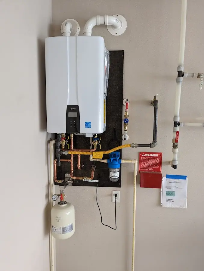 Professional plumber installing copper piping in a Monmouth home